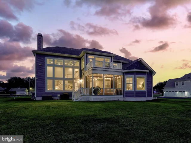 a front view of a house with garden and porch