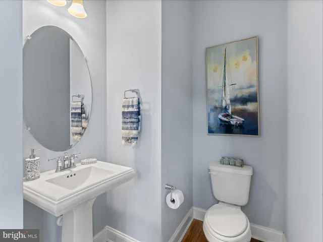 a bedroom with two beds and a painting on the wall