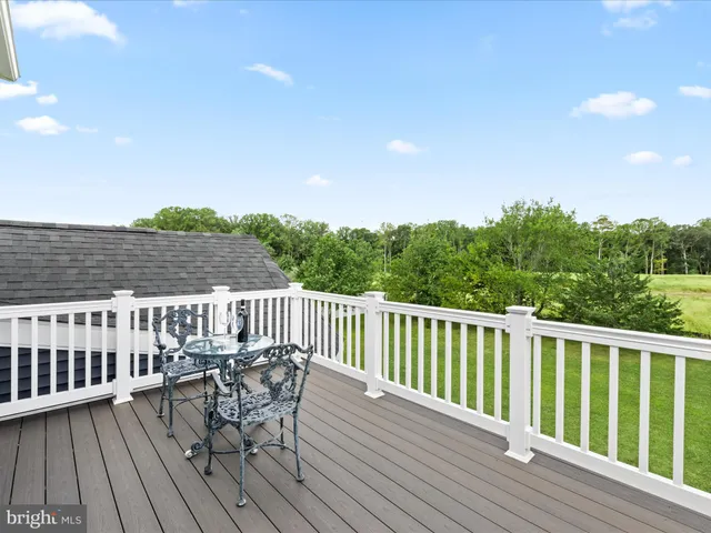 a view of a patio with dining table and chairs with wooden floor