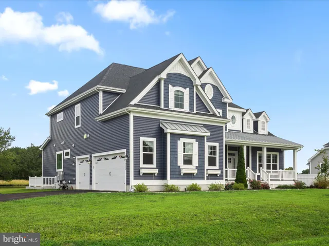 a kitchen with stainless steel appliances a stove a white cabinets and a refrigerator