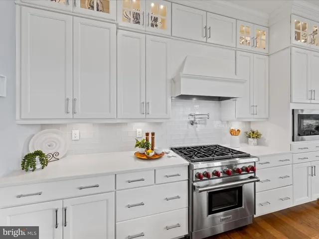 a view of a dining room with furniture large windows and wooden floor