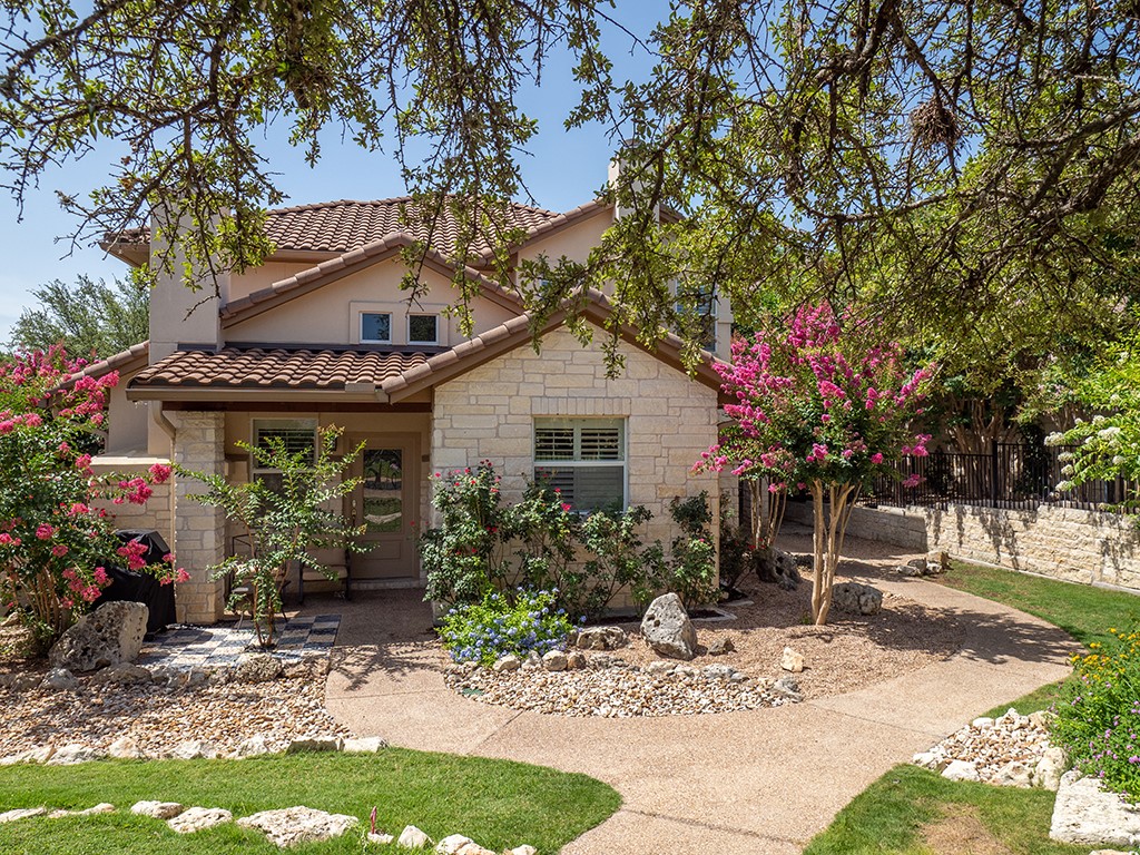 55 Tournament Way, Unit B The Hills, TX 78738 - Photo 1 of 23 a front view of a house with garden