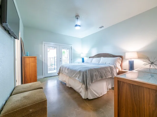 a bedroom with a bed and a chandelier
