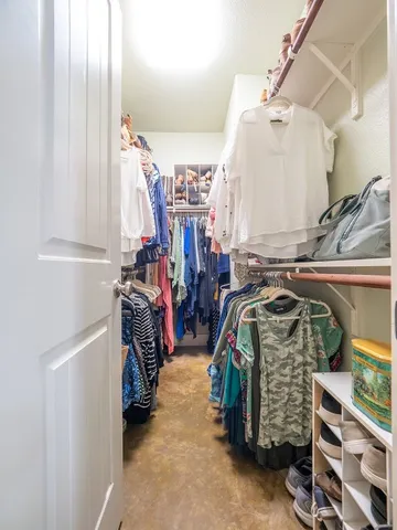 a living room with furniture a flat screen tv and a bookshelf