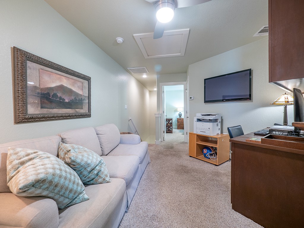 55 Tournament Way, Unit B The Hills, TX 78738 - Photo 23 of 23 a living room with furniture and a flat screen tv