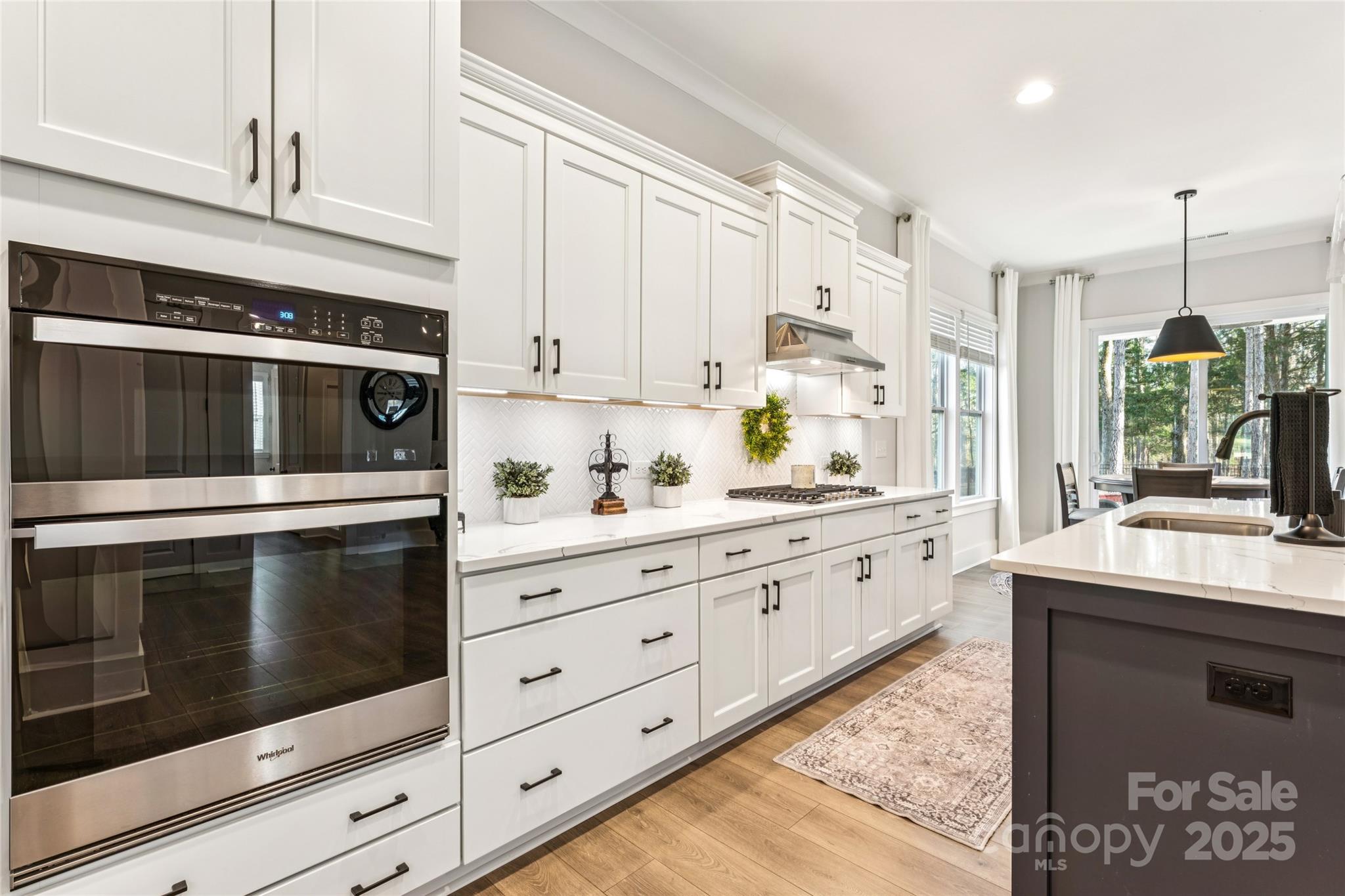 7822 Russell Road Indian Trail, NC 28079 - Photo 11 of 48 a kitchen with granite countertop white cabinets stainless steel appliances and a counter space