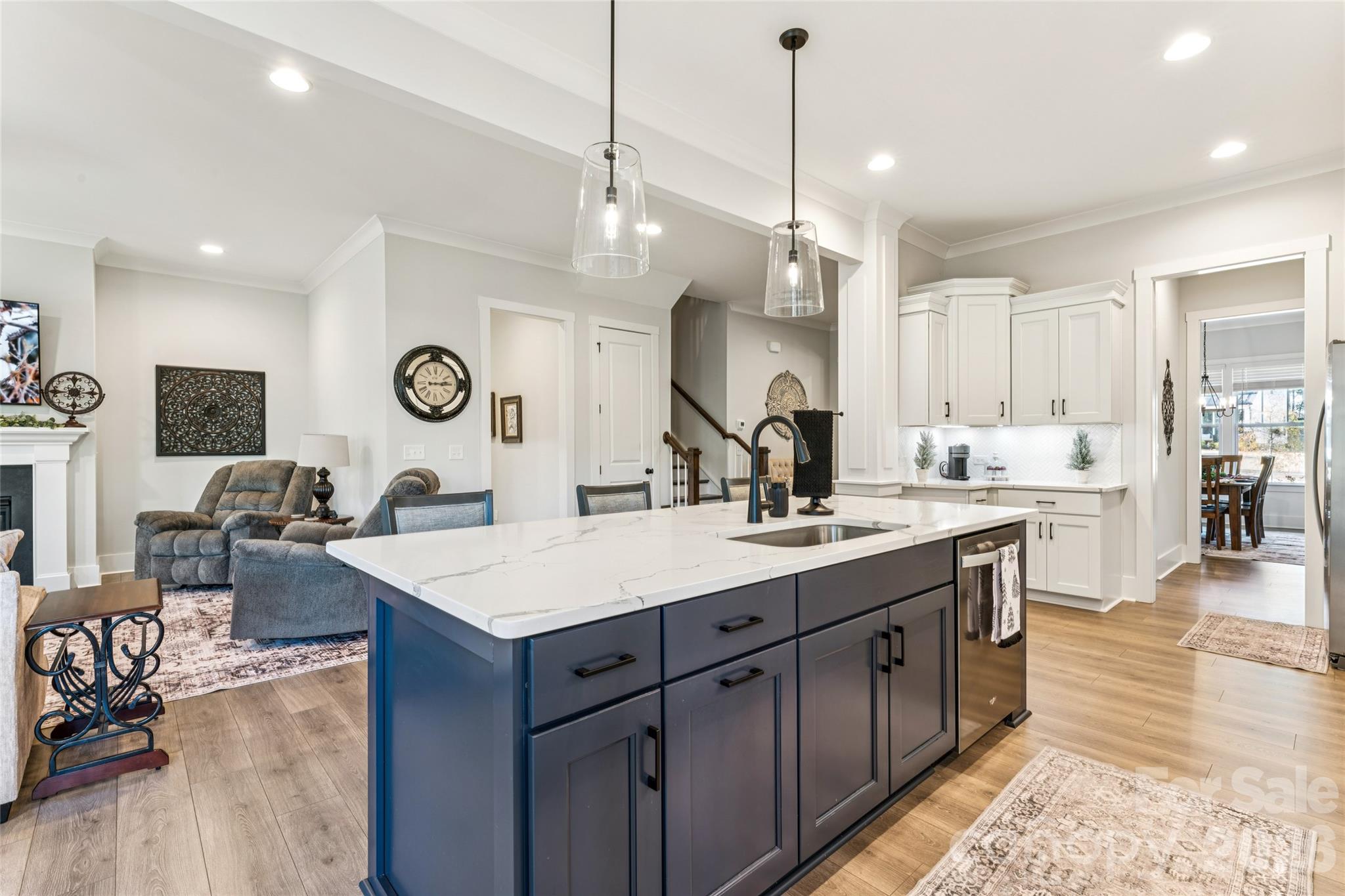 7822 Russell Road Indian Trail, NC 28079 - Photo 14 of 48 a large kitchen with a center island wooden floor stainless steel appliances and a view of living room
