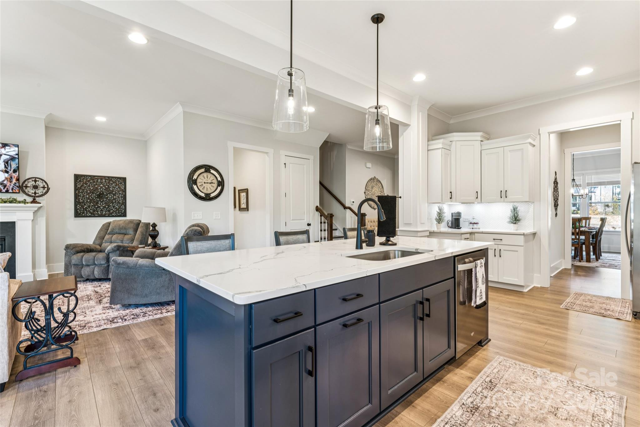 7822 Russell Road Indian Trail, NC 28079 - Photo 15 of 48 a large kitchen with a center island wooden floor stainless steel appliances and a view of living room