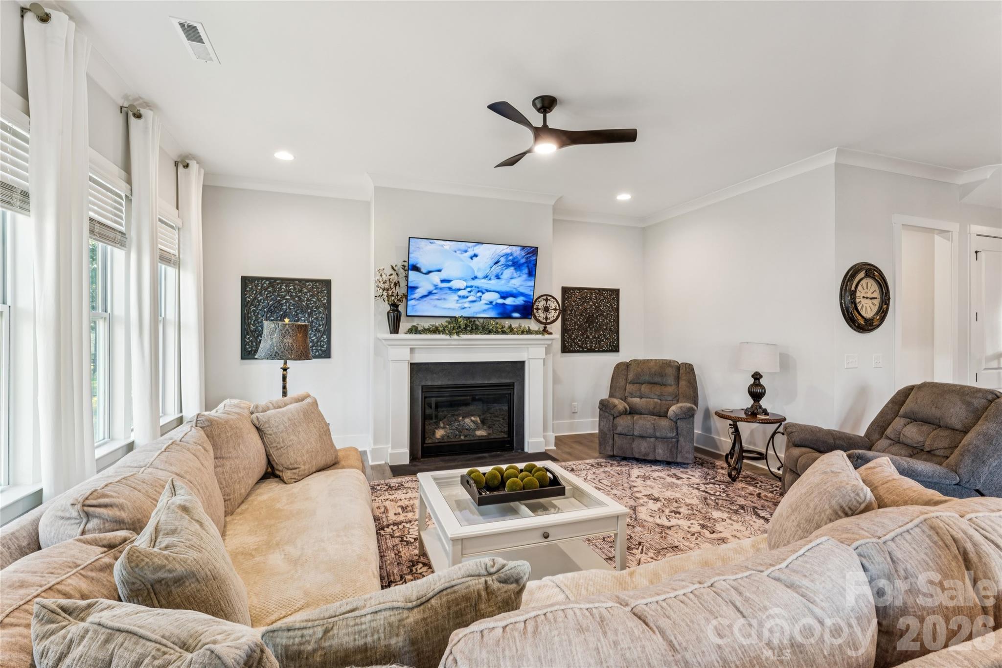 7822 Russell Road Indian Trail, NC 28079 - Photo 16 of 48 a living room with furniture a fireplace and a large window