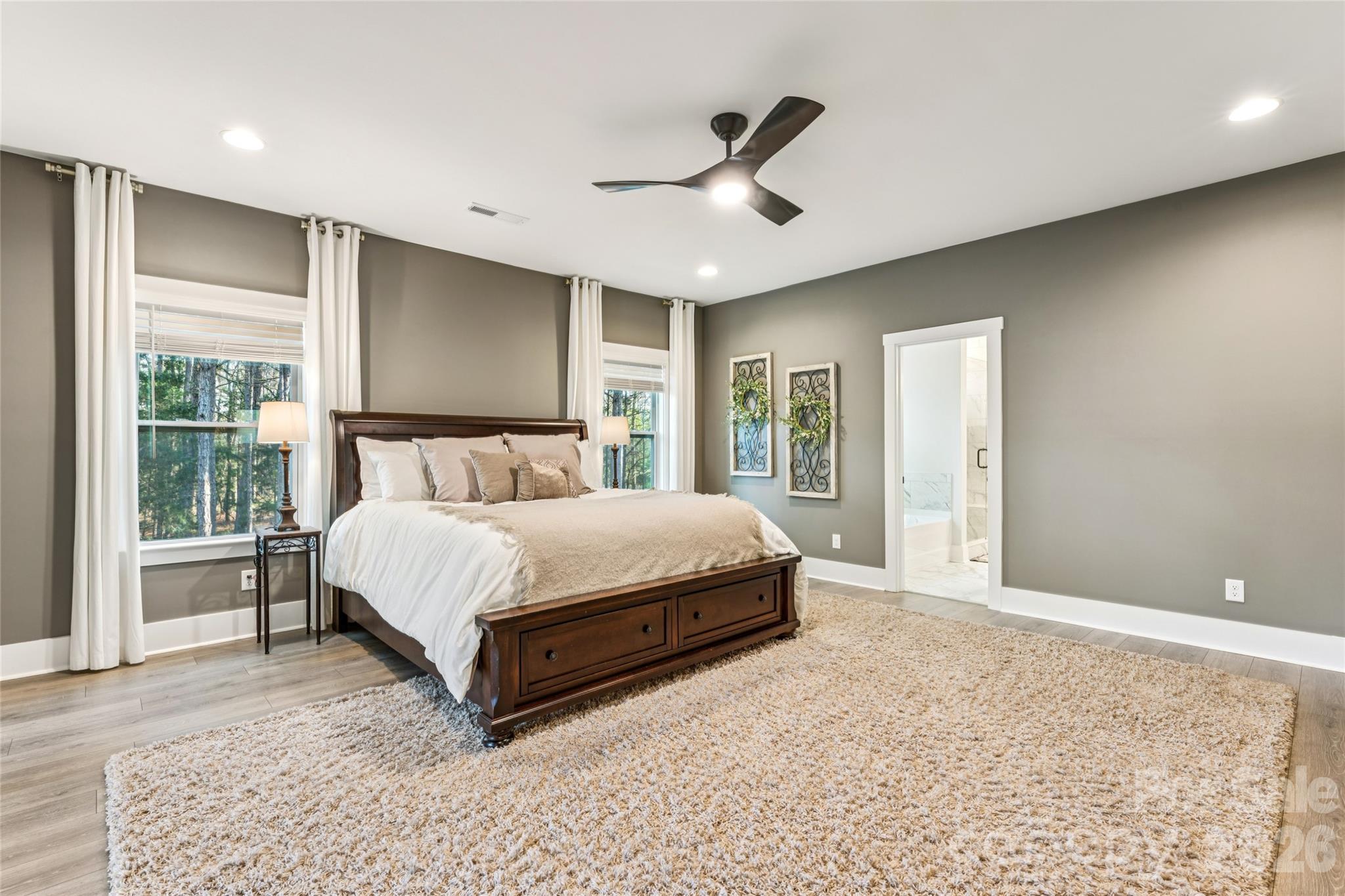7822 Russell Road Indian Trail, NC 28079 - Photo 29 of 48 a spacious bedroom with a large bed and a large window