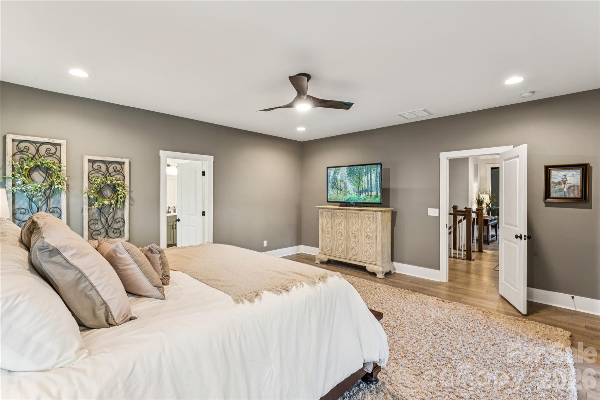 7822 Russell Road Indian Trail, NC 28079 - Photo 32 of 48 a bed room with a bed and a chandelier