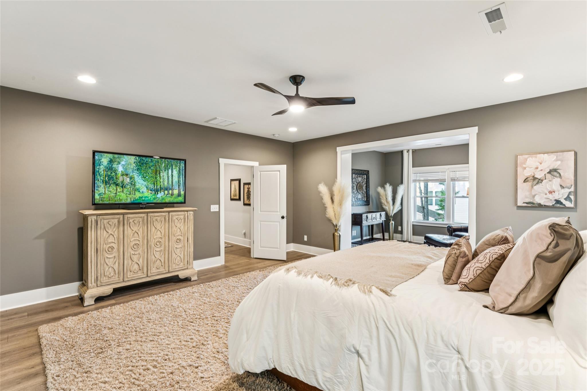 7822 Russell Road Indian Trail, NC 28079 - Photo 32 of 48 a bedroom with a large bed a flat tv screen and dresser