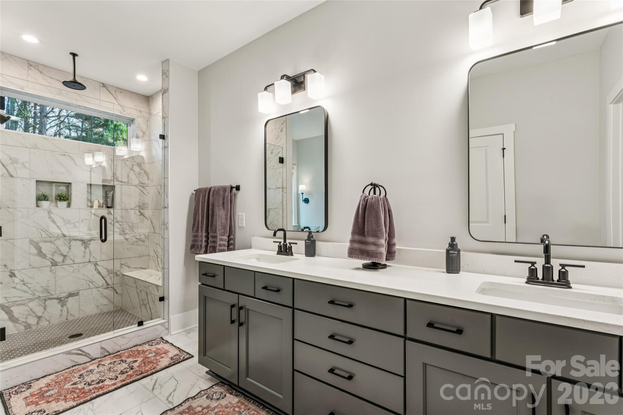 7822 Russell Road Indian Trail, NC 28079 - Photo 34 of 48 a bathroom with a double vanity sink mirror and shower