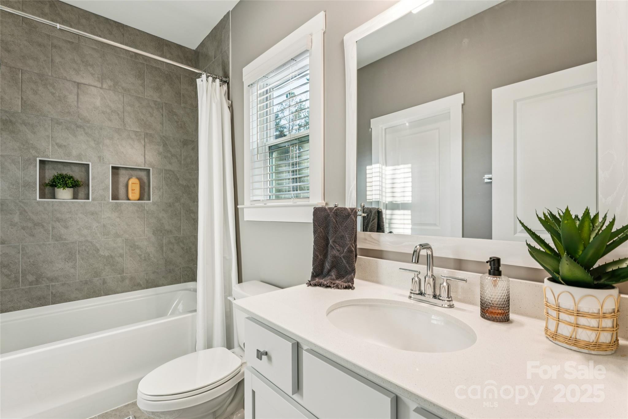 7822 Russell Road Indian Trail, NC 28079 - Photo 43 of 48 a bathroom with a granite countertop sink toilet a mirror and shower