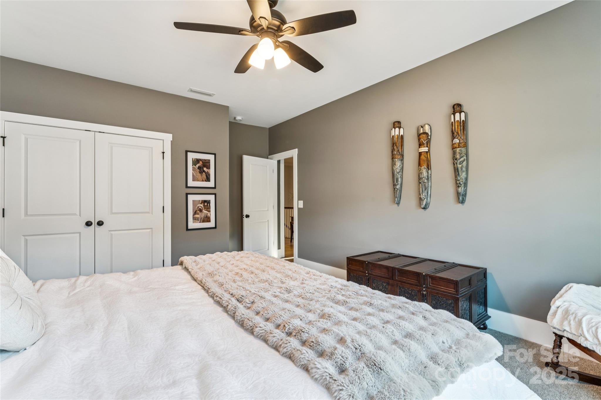 7822 Russell Road Indian Trail, NC 28079 - Photo 45 of 48 a bedroom with a bed and a chandelier