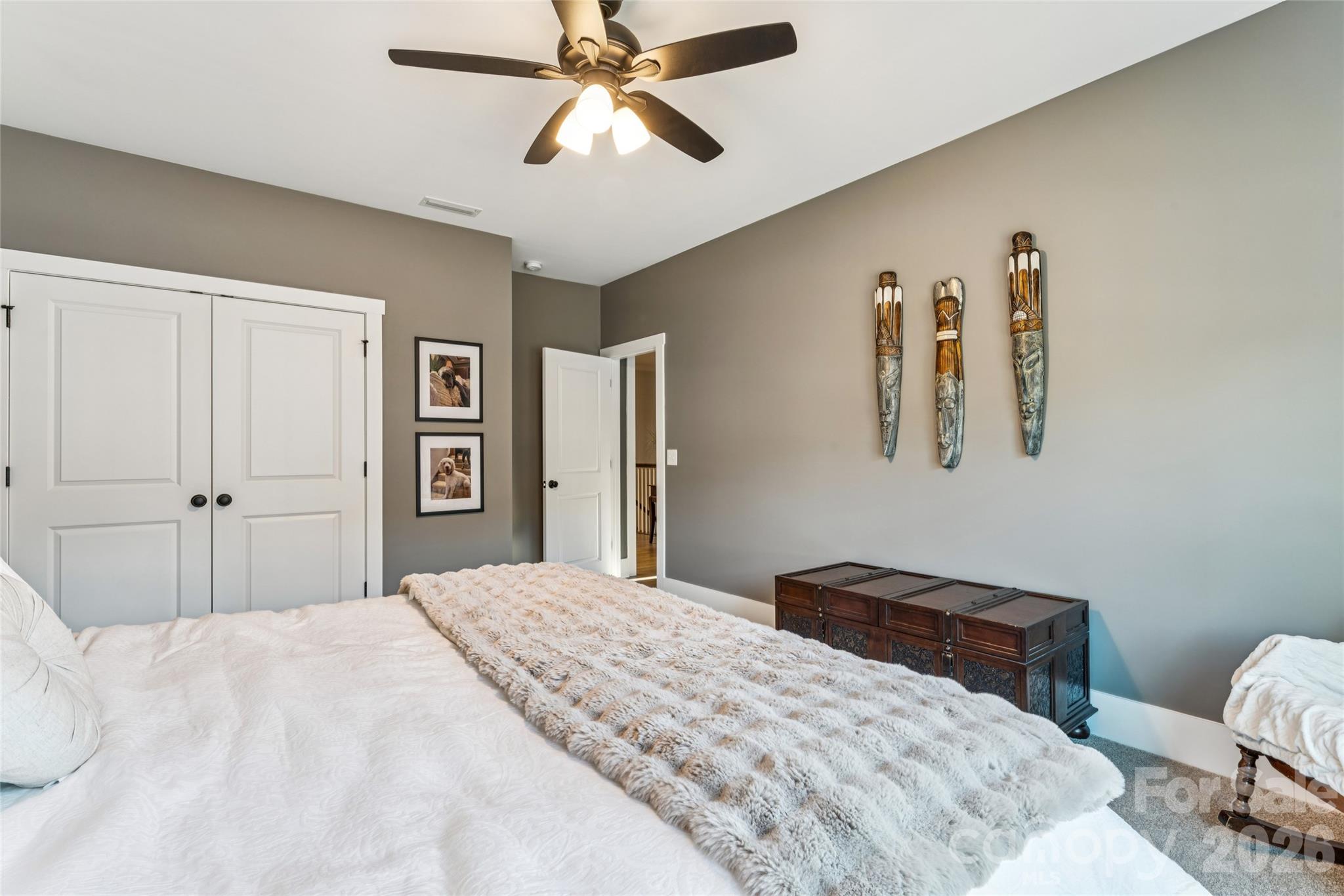 7822 Russell Road Indian Trail, NC 28079 - Photo 46 of 48 a bedroom with a bed and a chandelier
