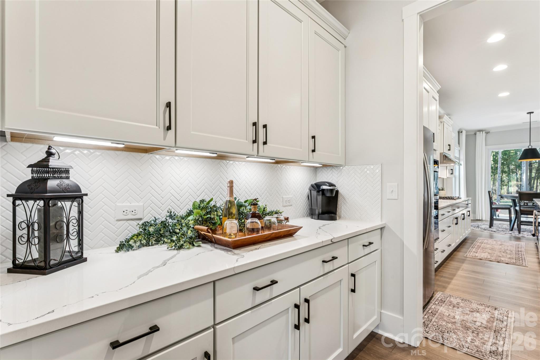 7822 Russell Road Indian Trail, NC 28079 - Photo 7 of 48 a kitchen with white cabinets and appliances