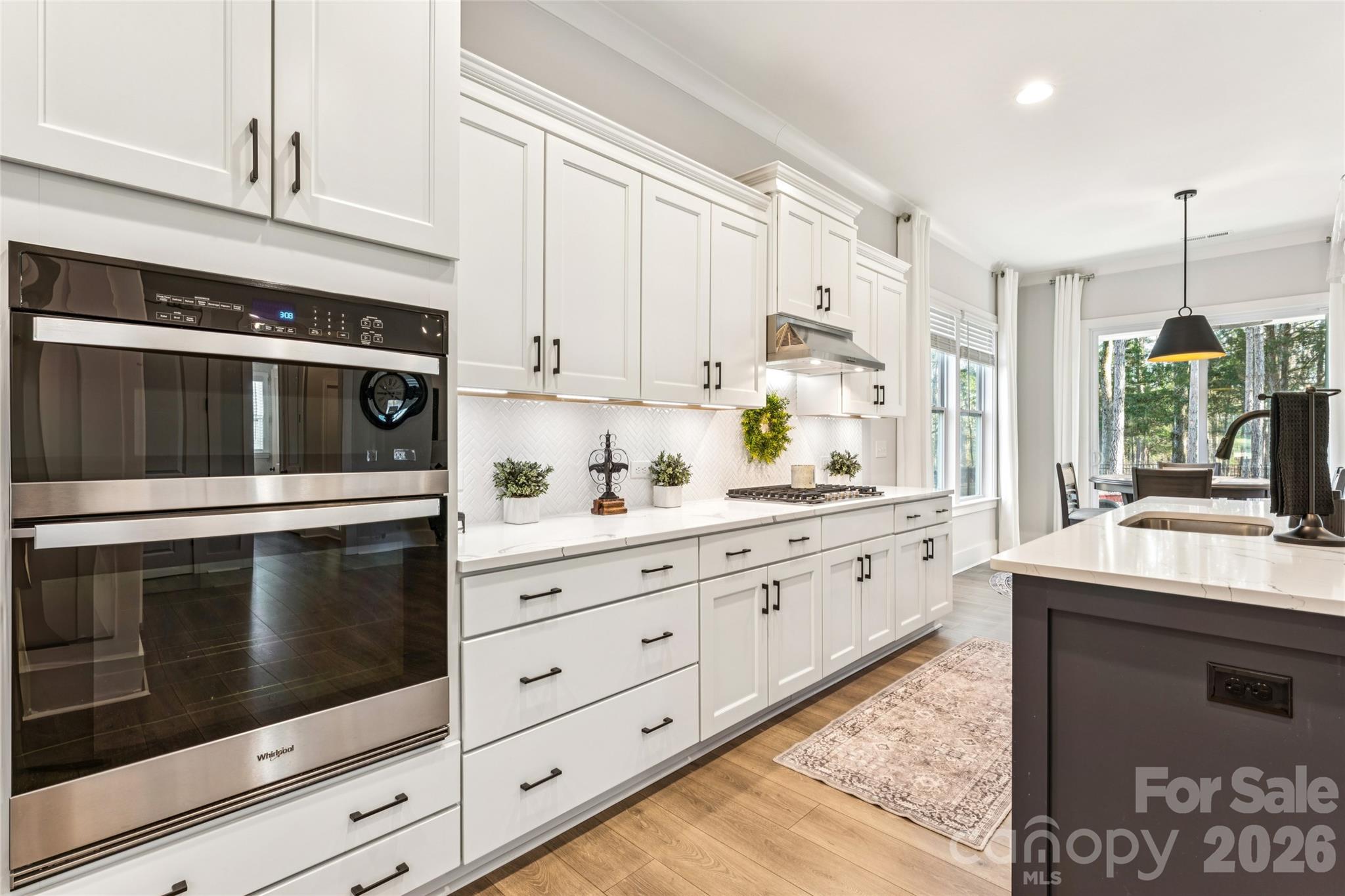 7822 Russell Road Indian Trail, NC 28079 - Photo 10 of 48 a kitchen with granite countertop white cabinets stainless steel appliances and a counter space