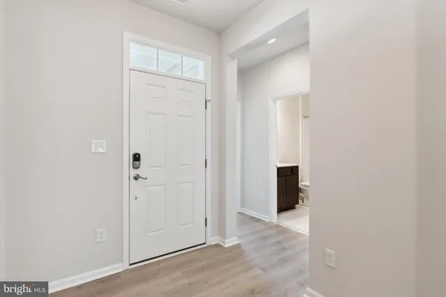 a view of an empty room with closet and a window