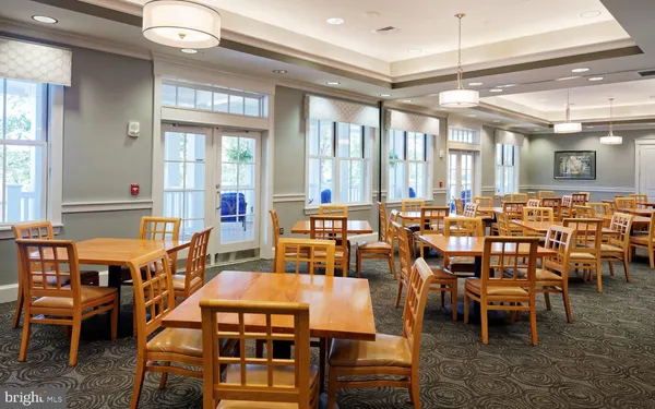 a kitchen with stainless steel appliances granite countertop a table and chairs in it