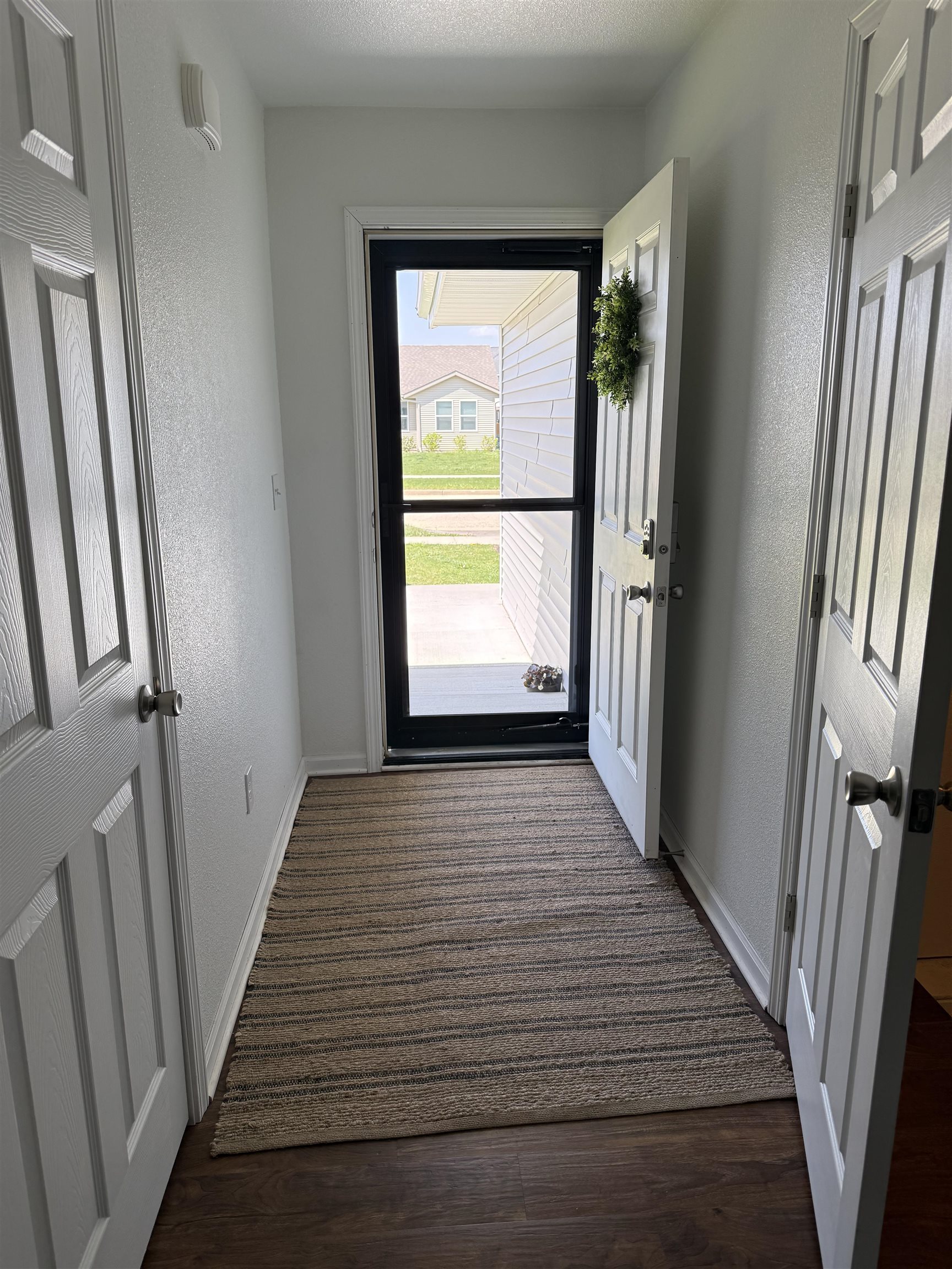 1135 Russell Road Belvidere, IL 61008 - Photo 8 of 11 a view of a hallway with wooden floor and staircase