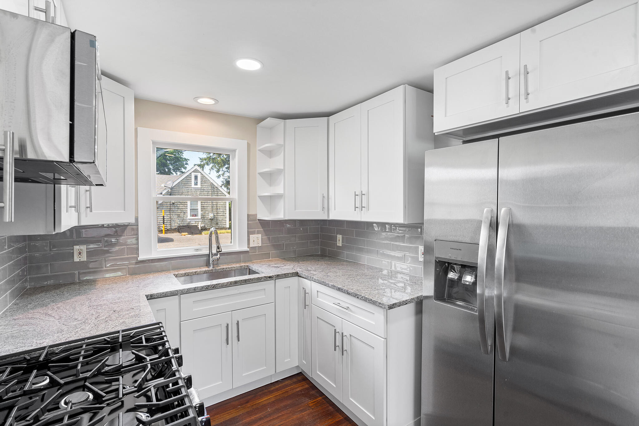 93 Sea Street Hyannis, MA 02601 - Photo 11 of 30 a kitchen with a sink stove and refrigerator