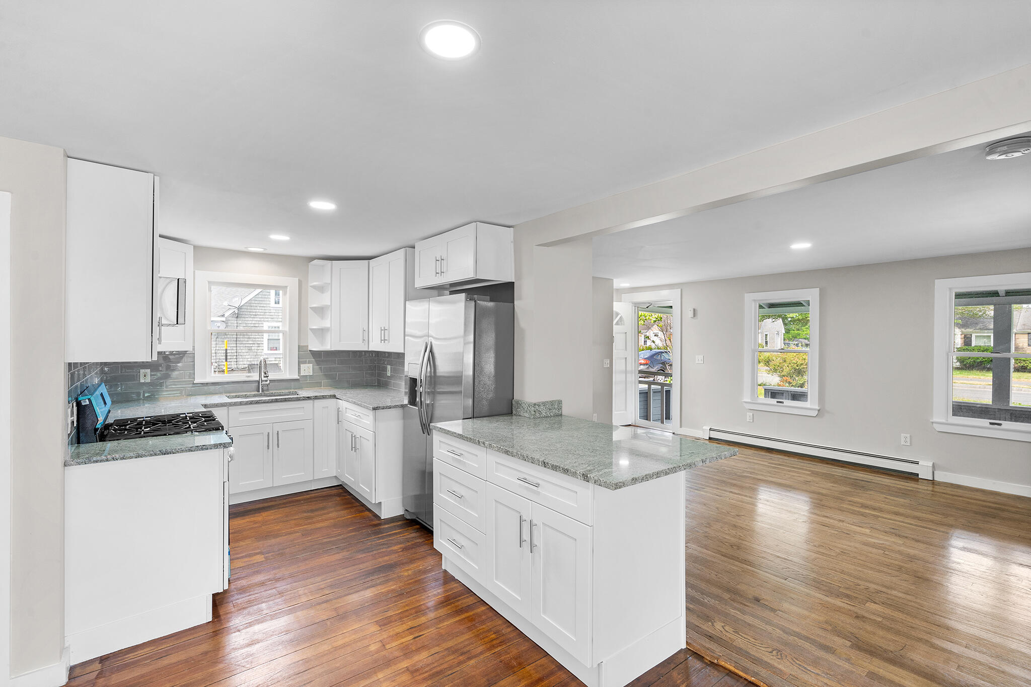 93 Sea Street Hyannis, MA 02601 - Photo 9 of 30 a kitchen with sink cabinets and wooden floor