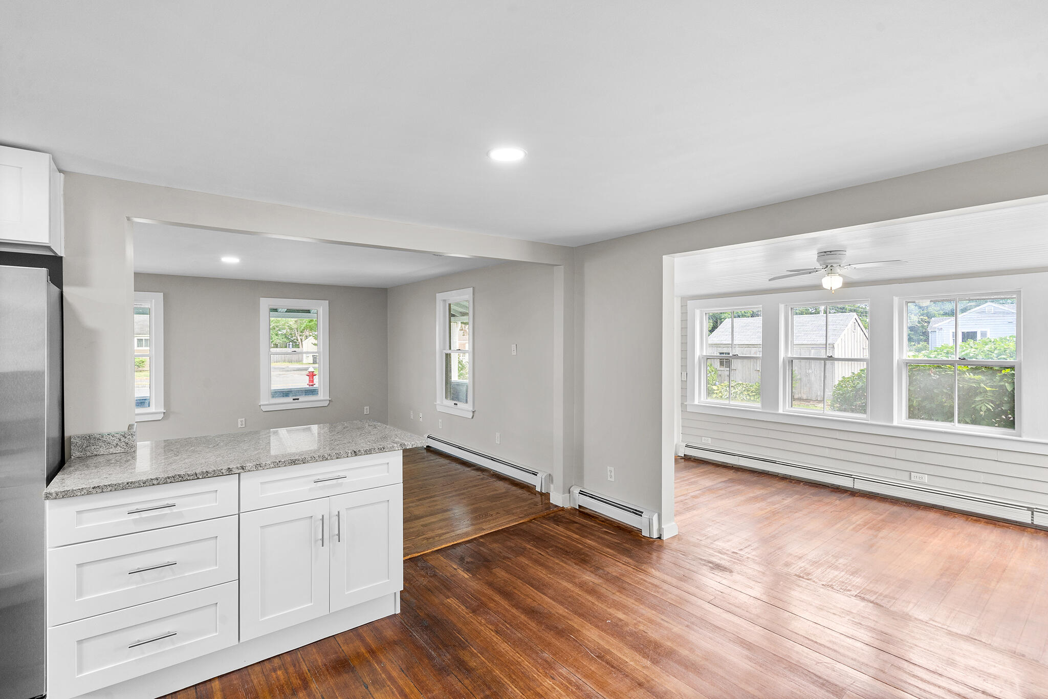 93 Sea Street Hyannis, MA 02601 - Photo 10 of 30 a spacious bathroom with a granite countertop sink mirror and a bath tub