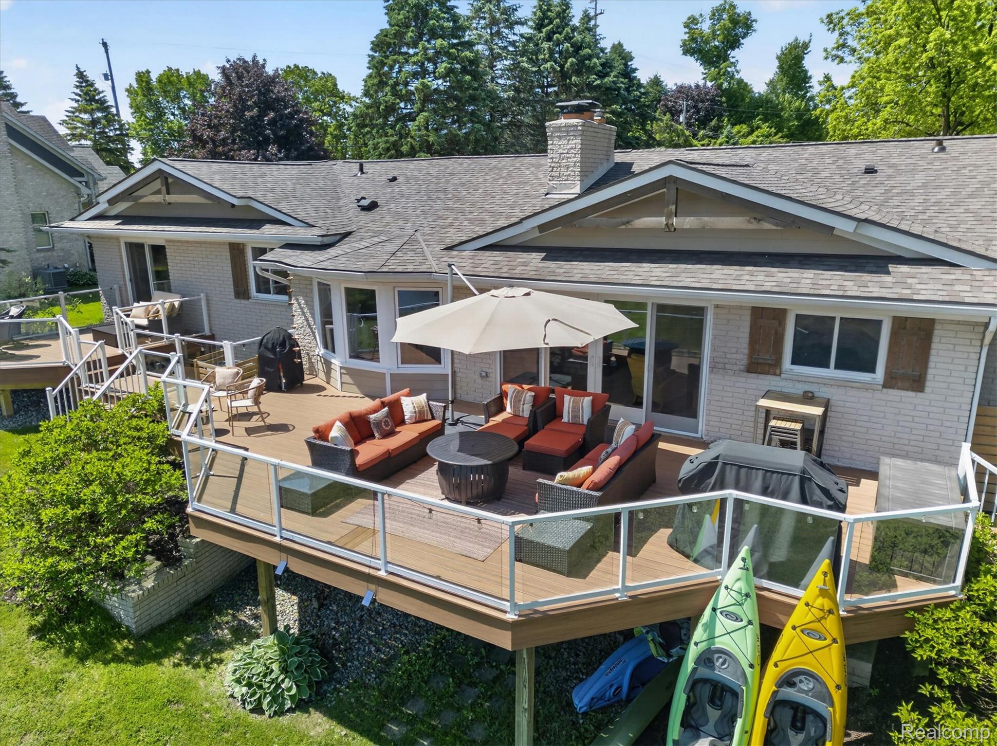 3860 East Commerce Road Commerce Township, MI 48382 - Photo 71 of 72 Multi-level exterior deck featuring composite decking and glass panel railings