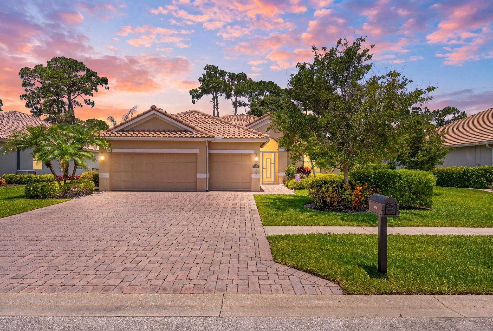 7657 Fieldstone Ranch Square Vero Beach, FL 32967 - Photo 1 of 52 a front view of a house with a yard and a garage
