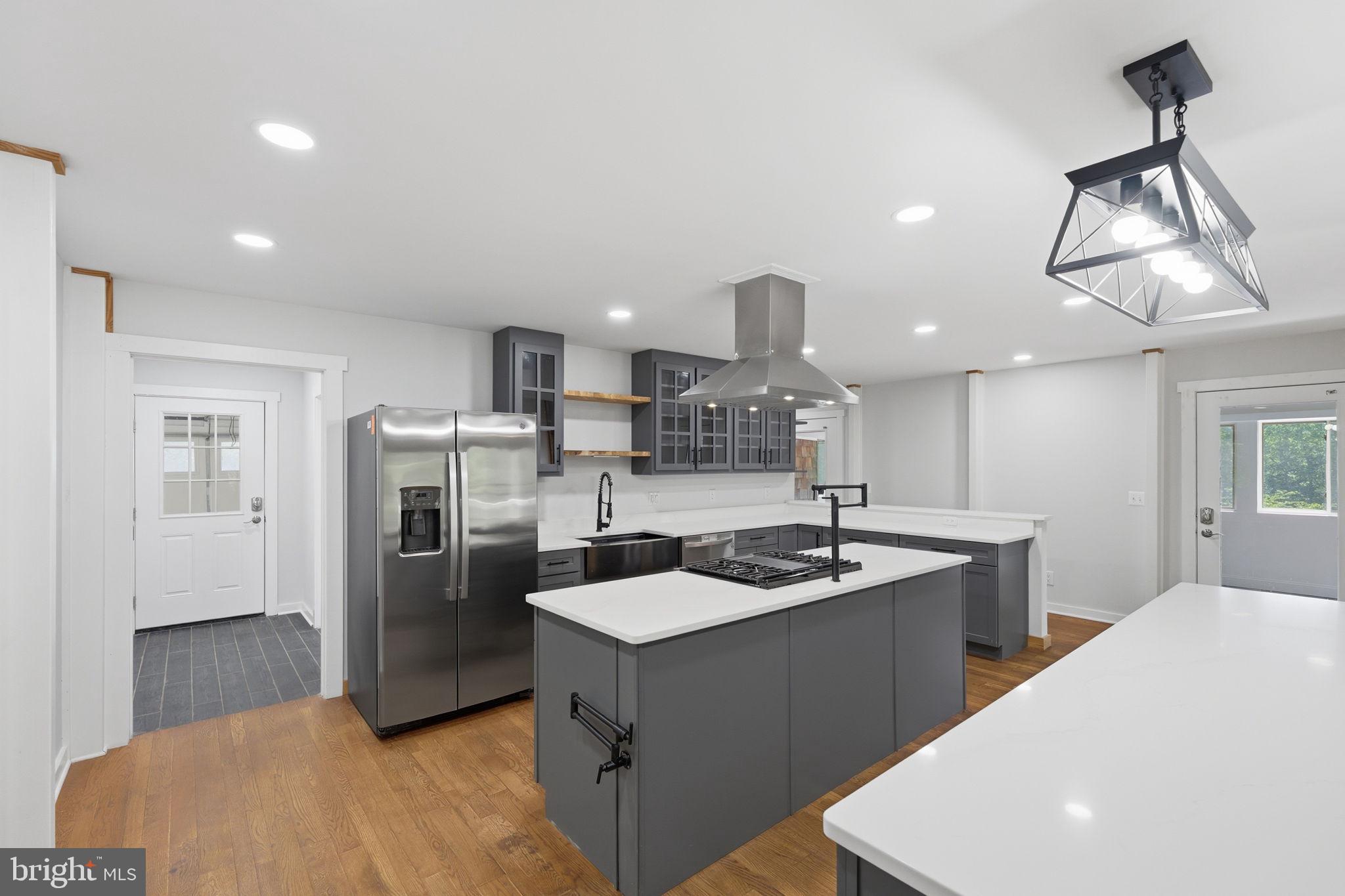 7522 Stubbs Bridge Road Spotsylvania, VA 22551 - Photo 16 of 60 a kitchen with stainless steel appliances granite countertop a sink a refrigerator and a stove