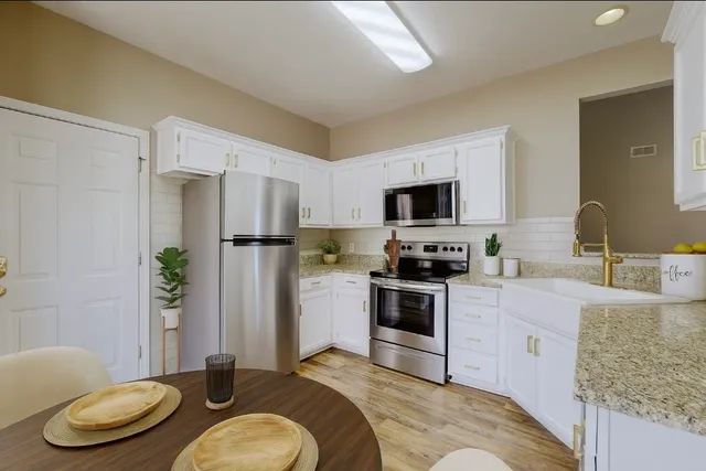 a kitchen with a refrigerator stove and sink
