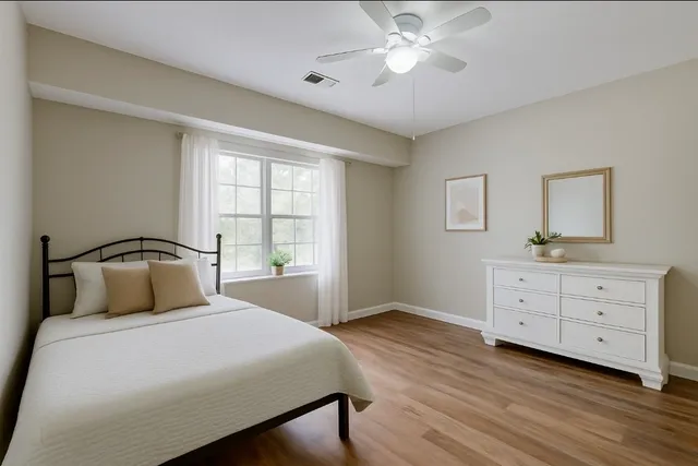 a bedroom with a large bed and a dresser