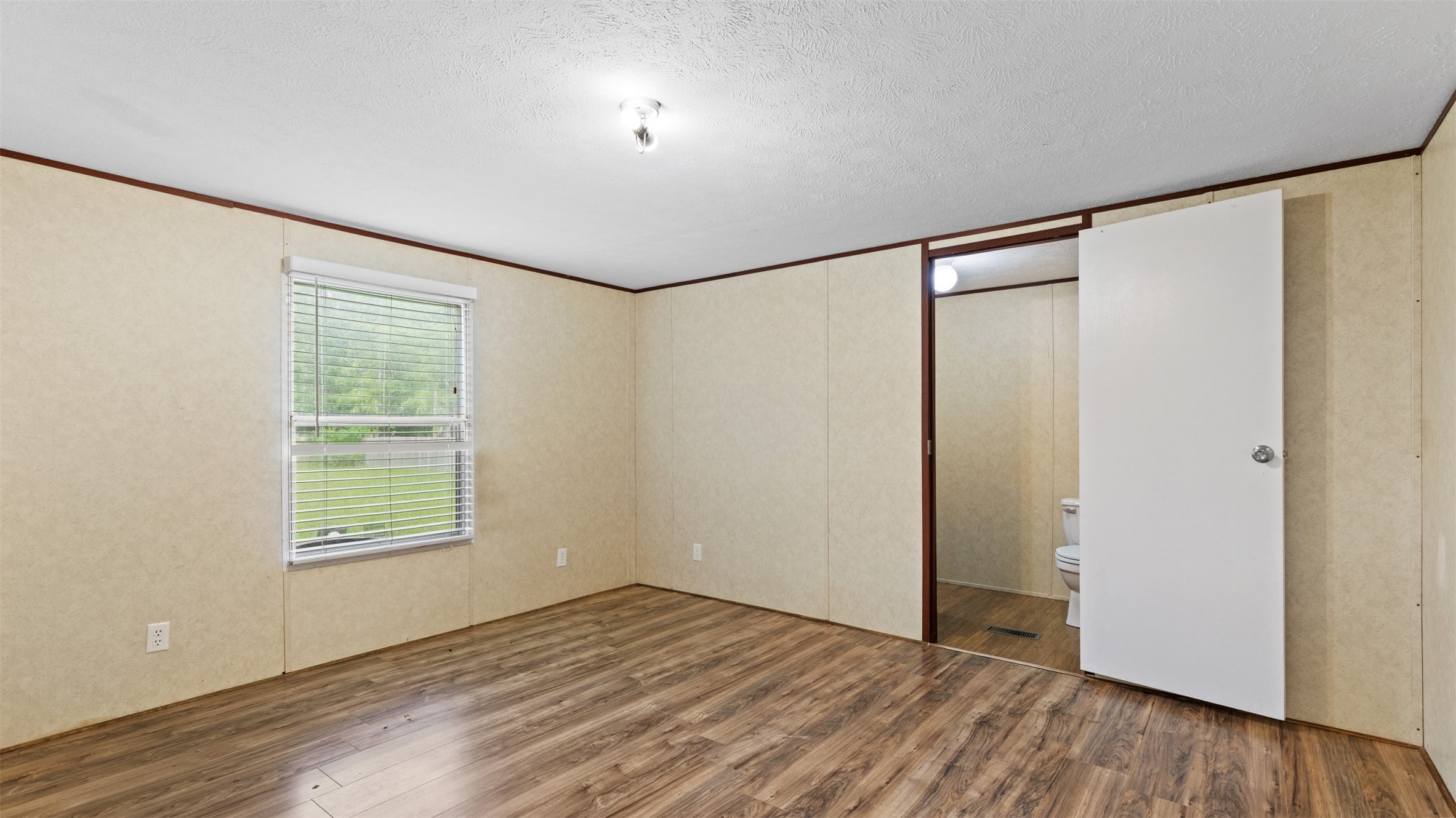 91 Maple Lane Shepherd, TX 77371 - Photo 9 of 15 a view of an empty room with wooden floor and a window