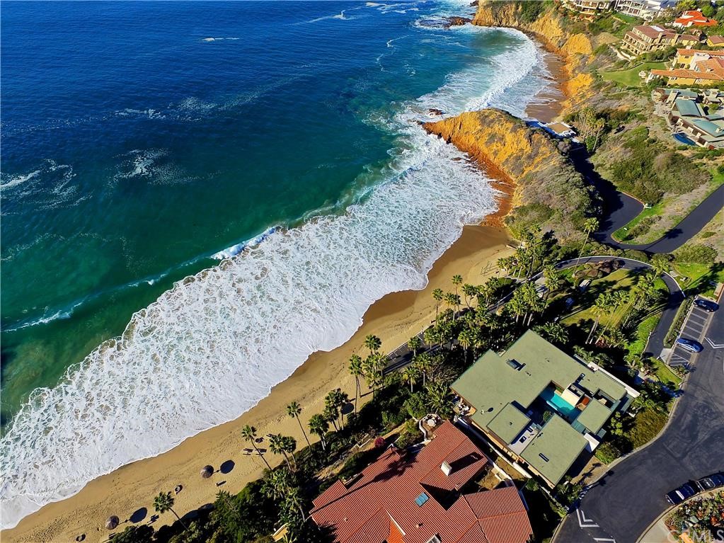 Aerial photography showing private Irvine Cove and home directly in front with the gray roof and pool.