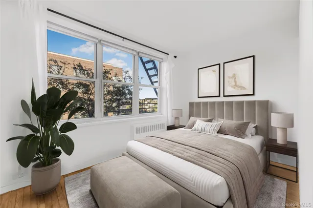 a bedroom with a bed and a potted plant