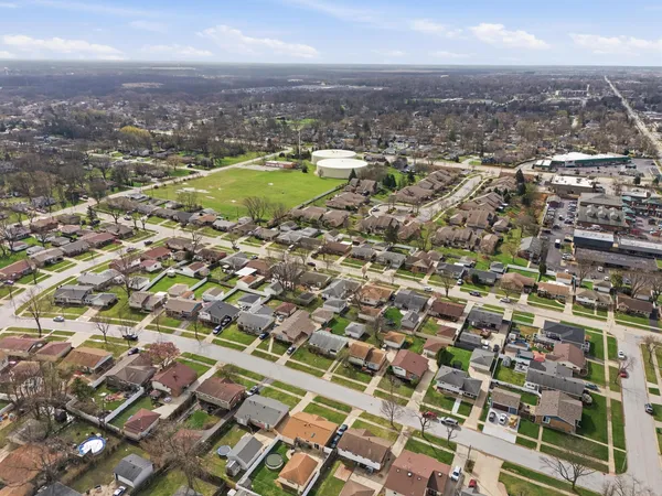 an aerial view of residential houses with city view