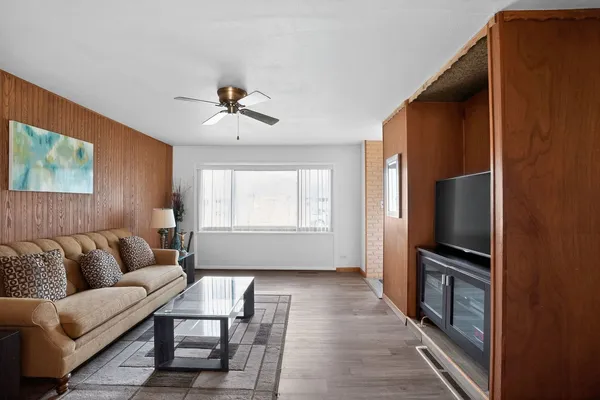 a living room with furniture flat screen tv and a window