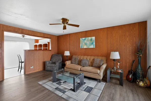 a living room with furniture and a wooden floor