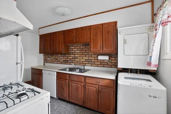 a kitchen with a sink stove and refrigerator