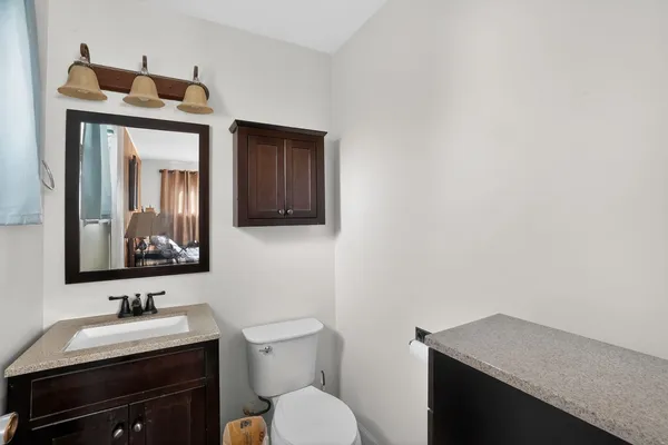 a bathroom with a toilet sink and mirror