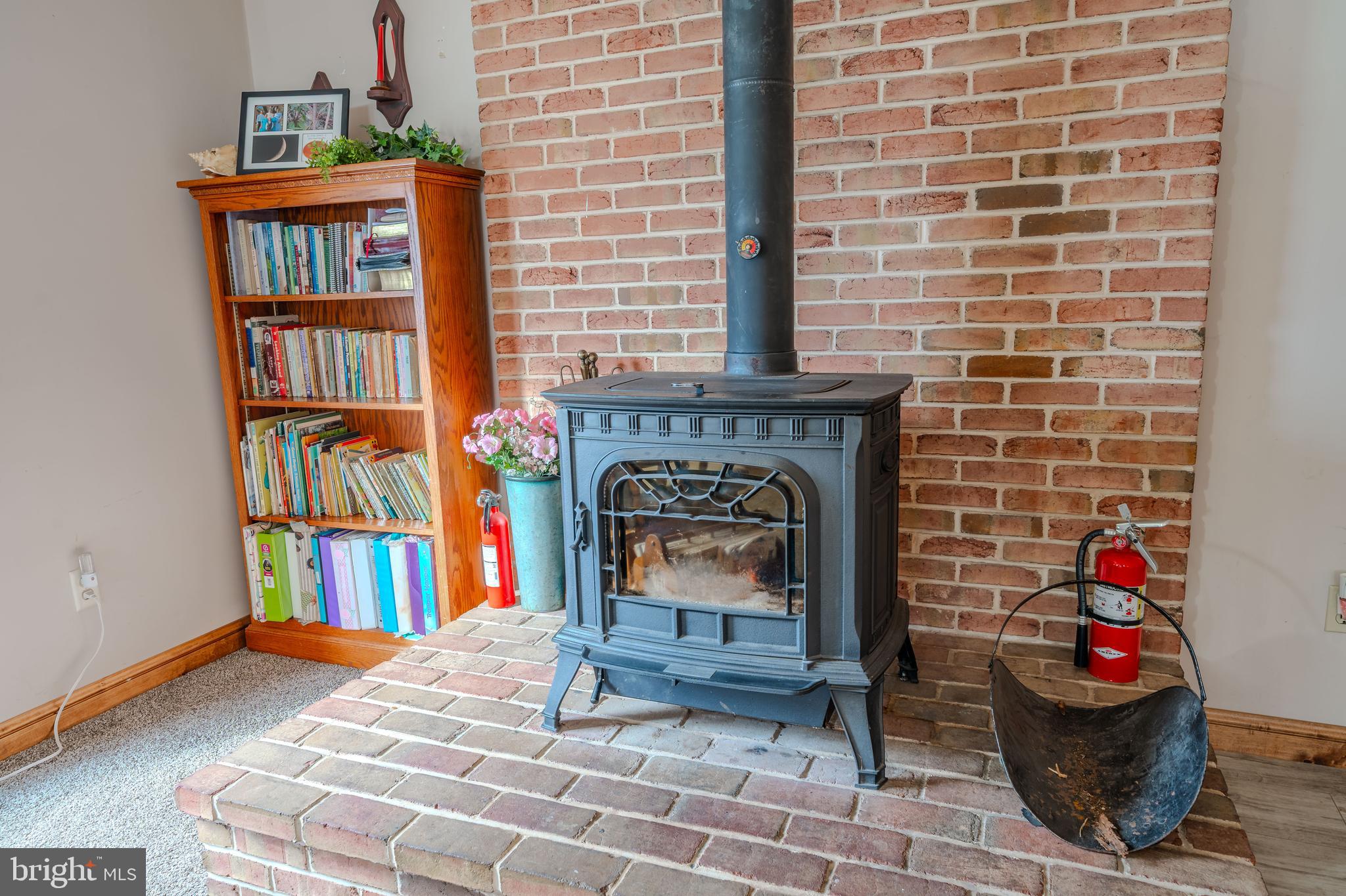 338 Culp Road Sunbury, PA 17801 - Photo 16 of 43 a living room with fireplace furniture and a book shelf