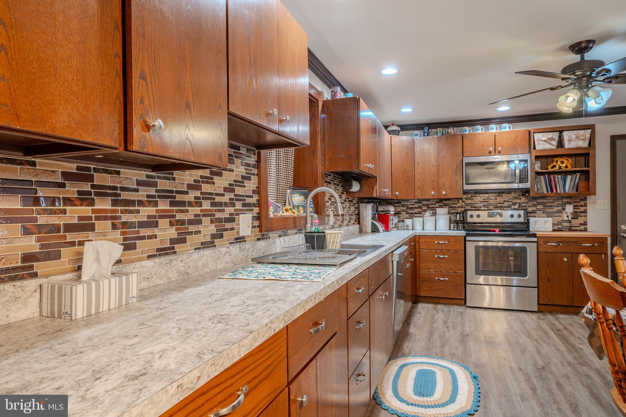 338 Culp Road Sunbury, PA 17801 - Photo 20 of 43 a kitchen with kitchen island granite countertop a stove and a sink