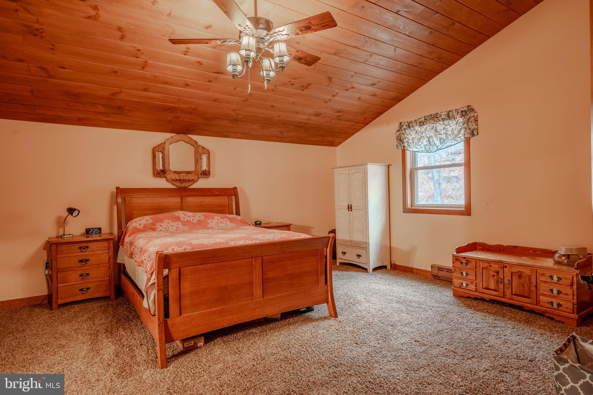 338 Culp Road Sunbury, PA 17801 - Photo 32 of 43 a bed sitting in a room next to a lamp