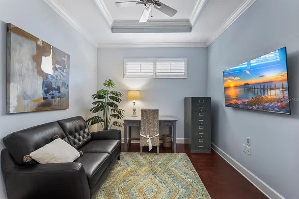 a bedroom with a bed and a table with wooden floor