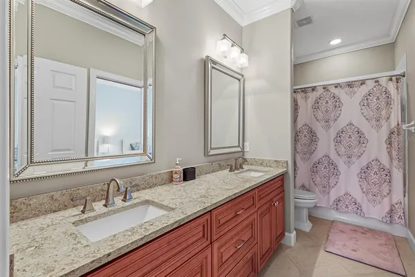 a bedroom with two beds and wooden floor