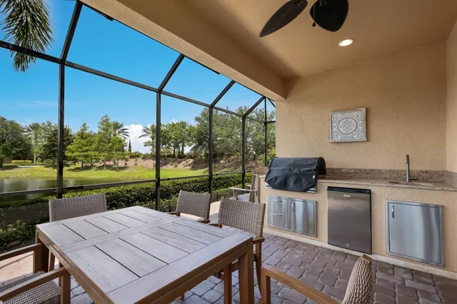 a view of a lake from a balcony with furniture