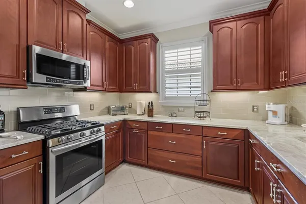a kitchen with stainless steel appliances granite countertop a refrigerator sink and cabinets