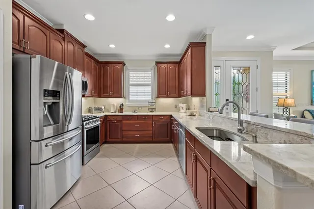a view of a dining room with furniture and chandelier