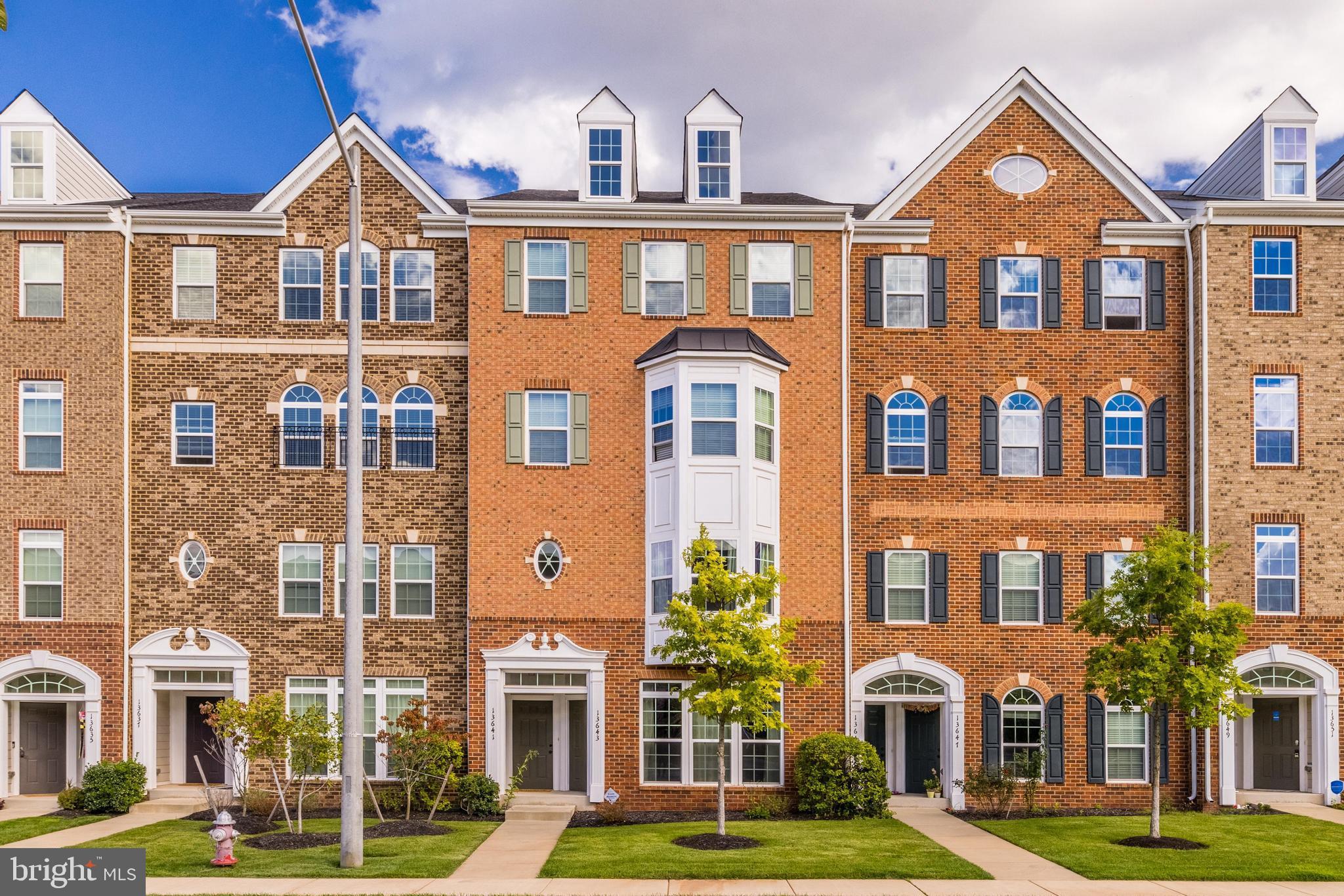 13643 Air And Parkway, Unit MUSEUM 9L Herndon, VA 20171 - Photo 1 of 45 a front view of a residential apartment building with a yard